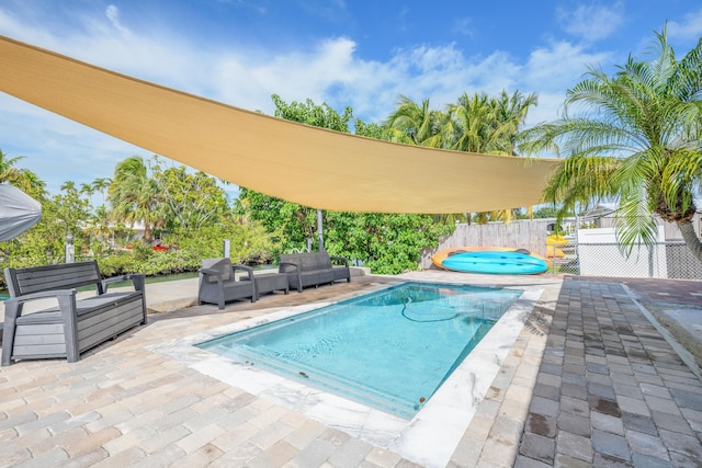 view of swimming pool featuring a patio, fence, and a fenced in pool