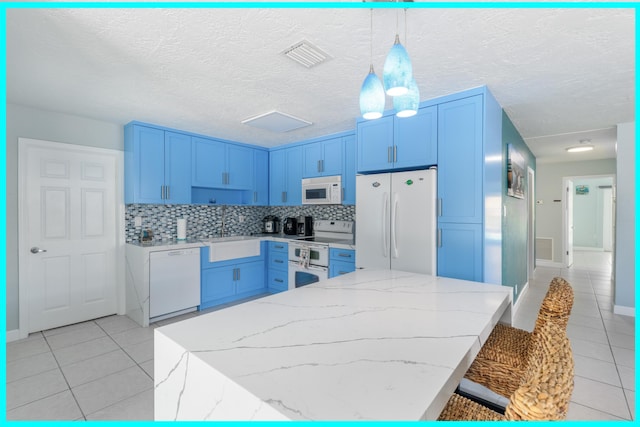 kitchen with light tile patterned flooring, sink, tasteful backsplash, hanging light fixtures, and white appliances