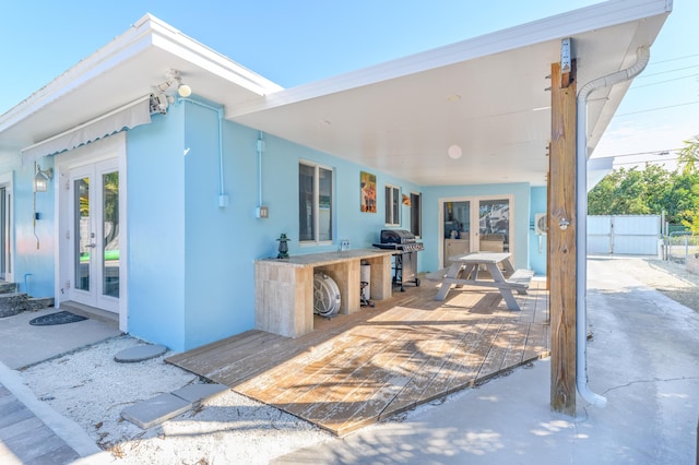 view of patio with french doors and a grill