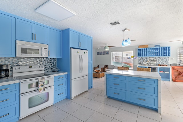 kitchen with visible vents, white appliances, a wealth of natural light, and blue cabinets