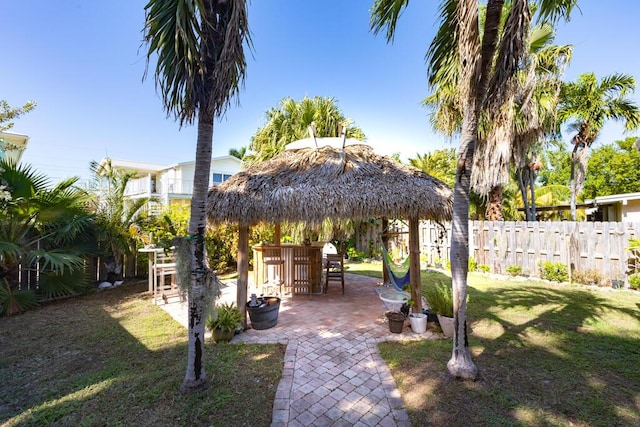 view of yard with a gazebo, a patio, and exterior bar