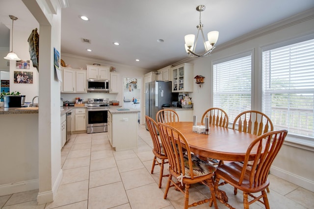 dining space with light tile patterned floors, a notable chandelier, and ornamental molding