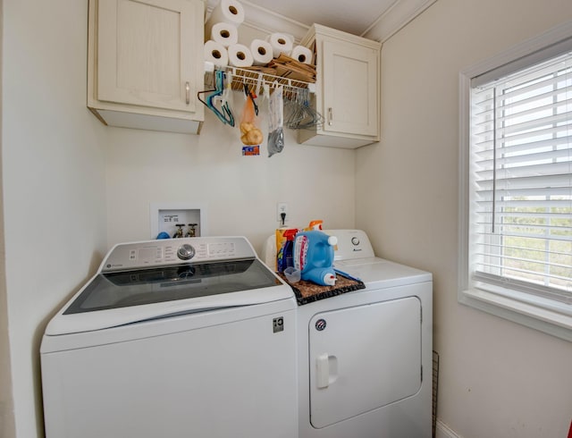 washroom with cabinets and washer and dryer