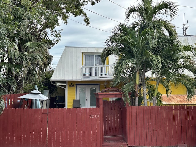 view of front facade featuring french doors and a balcony