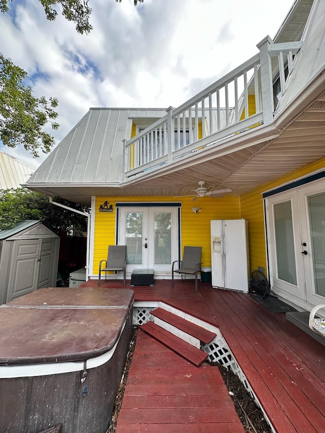 exterior space featuring french doors, ceiling fan, and a storage unit