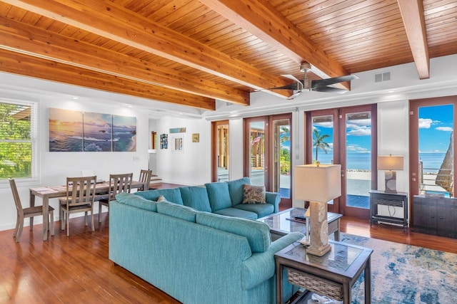 living room featuring hardwood / wood-style flooring, a wealth of natural light, wooden ceiling, and beamed ceiling