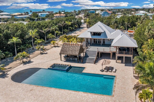 view of swimming pool with a wooden deck, a gazebo, a patio, and an in ground hot tub