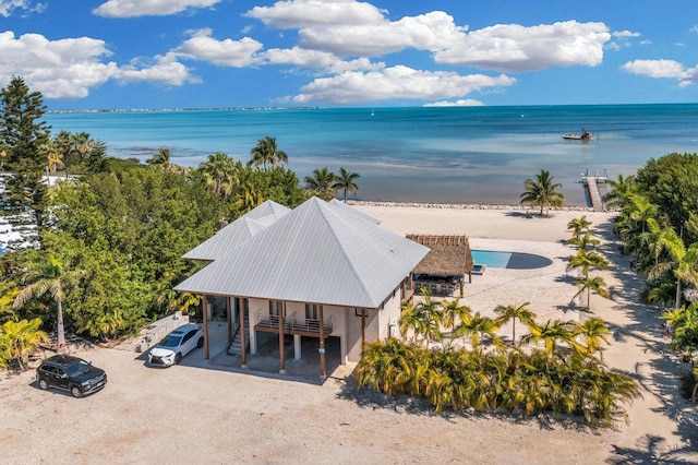 birds eye view of property with a water view and a view of the beach