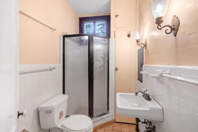 bathroom featuring sink, tile walls, tile patterned flooring, an enclosed shower, and toilet