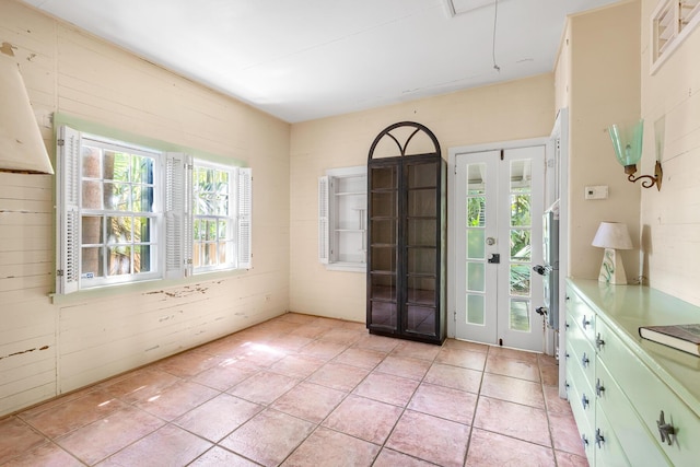 doorway to outside with light tile patterned flooring