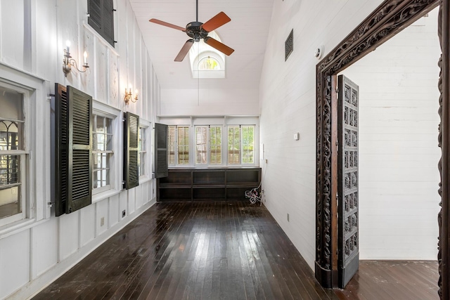 spare room with ceiling fan, dark hardwood / wood-style floors, and high vaulted ceiling