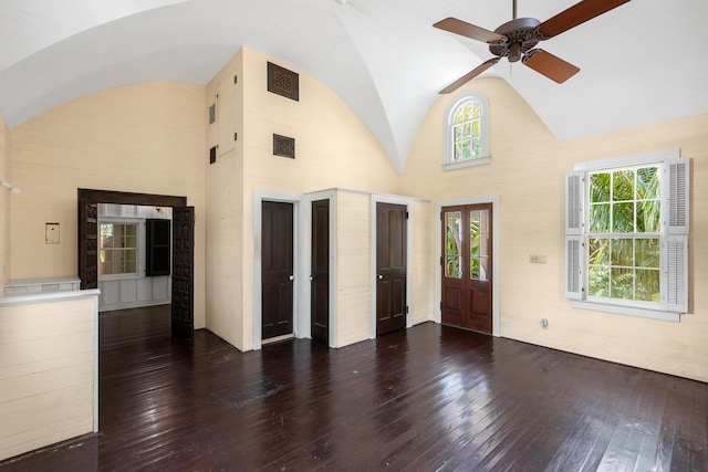 interior space with dark hardwood / wood-style flooring, high vaulted ceiling, and ceiling fan