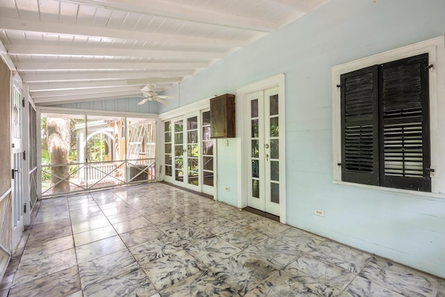 unfurnished sunroom featuring vaulted ceiling with beams, ceiling fan, and french doors