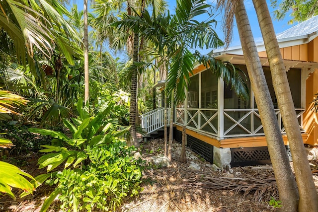 view of side of property with a sunroom