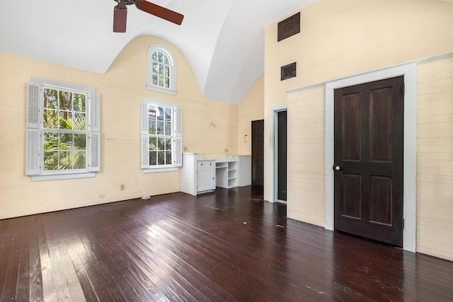 unfurnished living room with ceiling fan, dark hardwood / wood-style flooring, and high vaulted ceiling