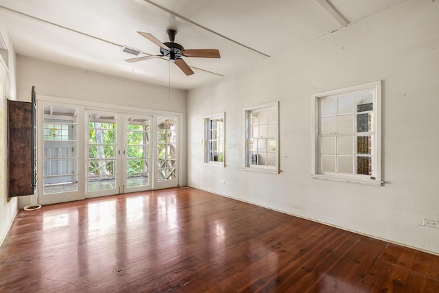 empty room with french doors, ceiling fan, and hardwood / wood-style flooring