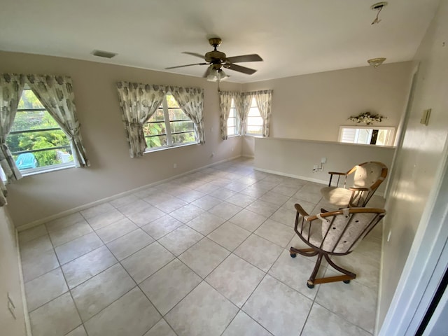 unfurnished room featuring light tile patterned floors and ceiling fan