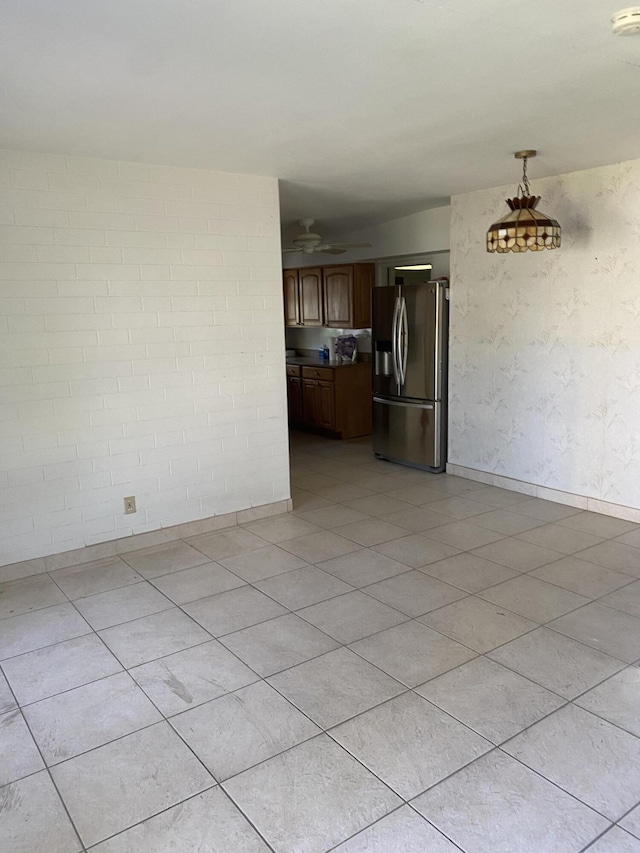 interior space with light tile patterned floors and ceiling fan