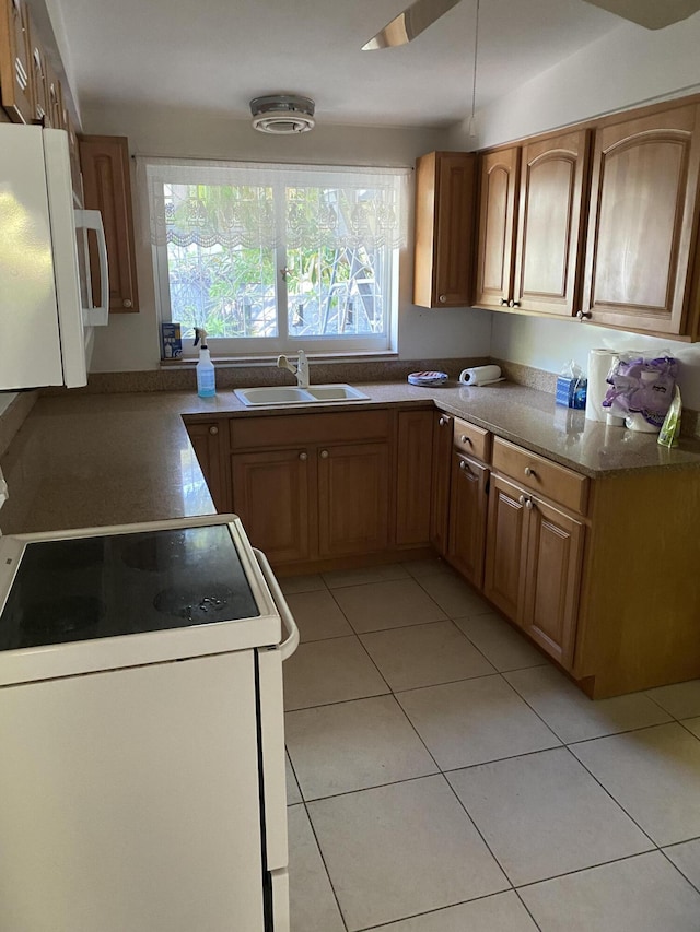 kitchen with sink, white electric range, fridge, and light tile patterned floors