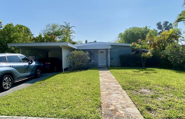 ranch-style home featuring a carport and a front yard