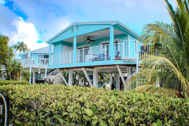 rear view of property featuring ceiling fan
