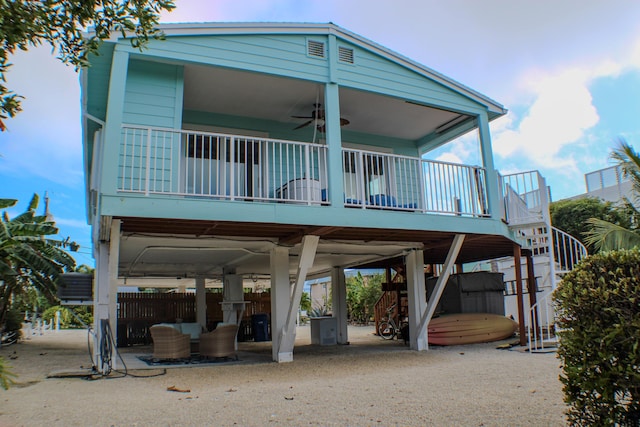 rear view of house featuring ceiling fan