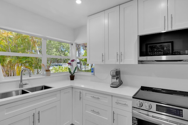 1412 Johnson St, Key West, FL 33040 - kitchen featuring stainless steel electric range, white cabinetry, light countertops, and recessed lighting