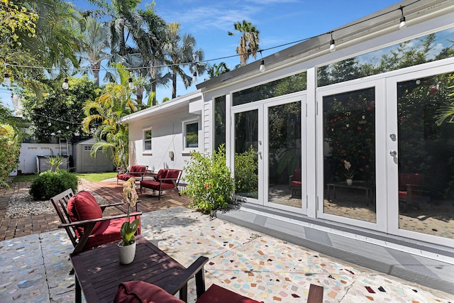 1412 Johnson St, Key West, FL 33040 - view of patio featuring a storage unit, french doors, and an outdoor living space