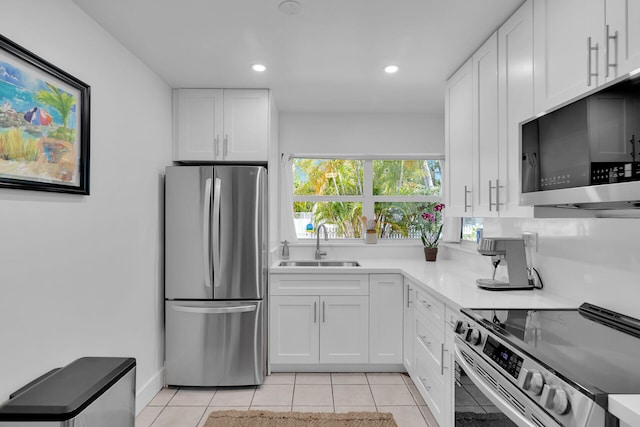 1412 Johnson St, Key West, FL 33040 - kitchen with stainless steel appliances, white cabinets, light tile patterned floors, recessed lighting, and light countertops