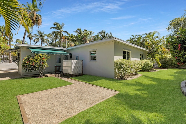 1412 Johnson St, Key West, FL 33040 - back of property with a lawn and stucco siding