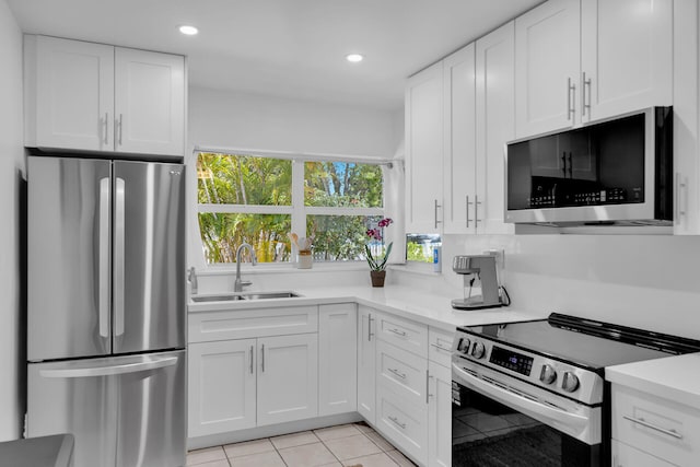 1412 Johnson St, Key West, FL 33040 - kitchen with appliances with stainless steel finishes, white cabinetry, light countertops, recessed lighting, and light tile patterned floors