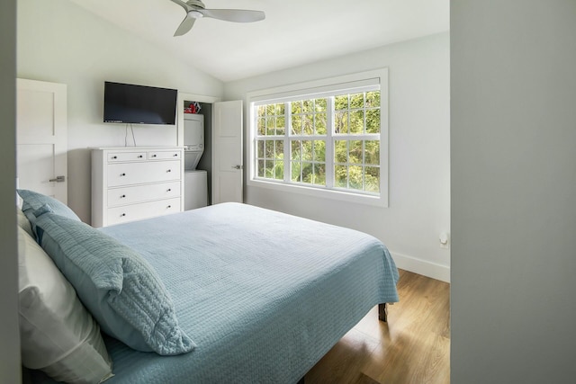 bedroom with vaulted ceiling, ceiling fan, wood finished floors, and baseboards