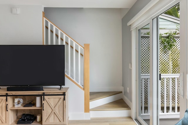 stairway with baseboards and wood finished floors