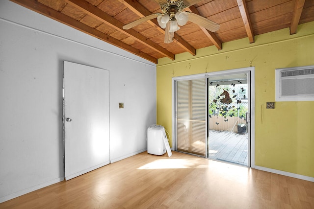 interior space with beamed ceiling, wood finished floors, a wall unit AC, wooden ceiling, and access to exterior