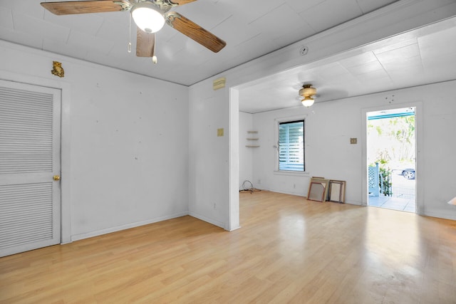 empty room with light wood-style flooring, baseboards, and ceiling fan