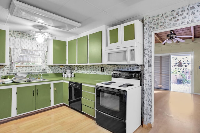 kitchen featuring green cabinetry, white microwave, ceiling fan, and electric range oven