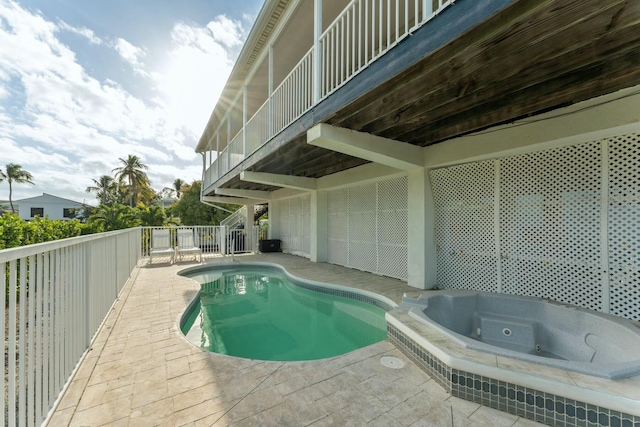 view of swimming pool featuring a patio and an in ground hot tub