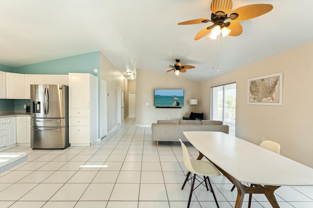 tiled dining space with vaulted ceiling