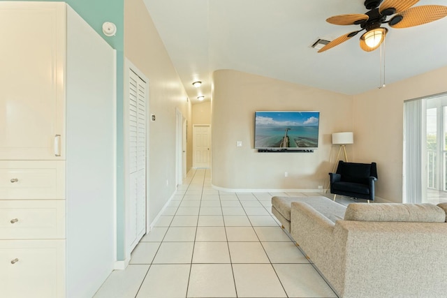 tiled living room with ceiling fan and lofted ceiling