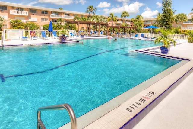 community pool featuring a patio area and fence