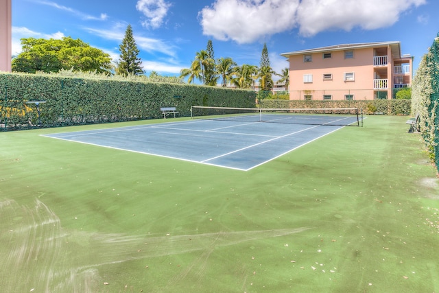 view of tennis court with fence