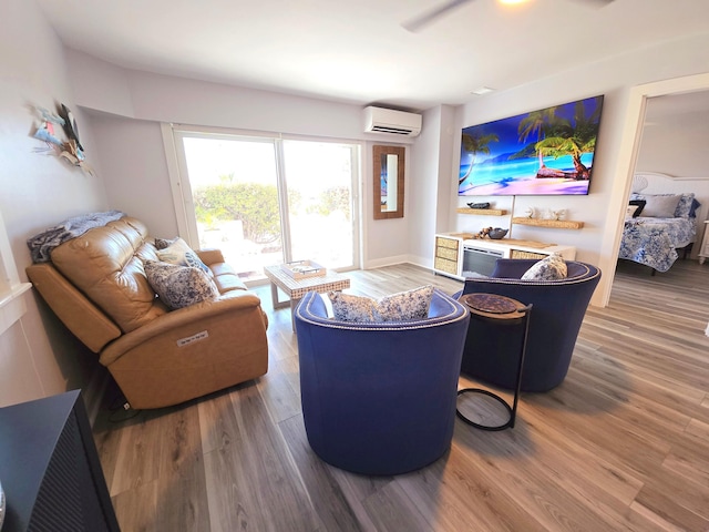 living room with wood finished floors and an AC wall unit