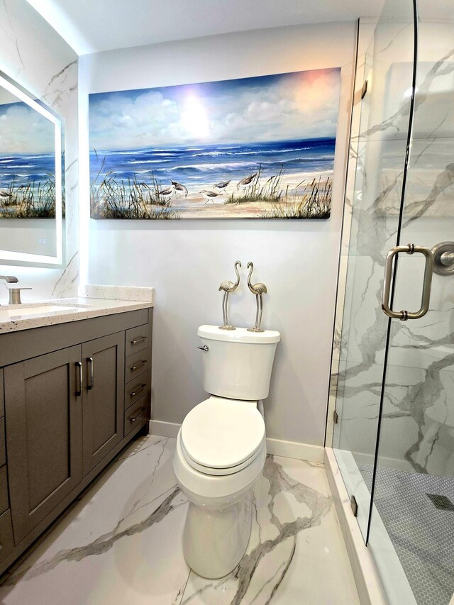 full bath featuring a marble finish shower, baseboards, toilet, marble finish floor, and vanity