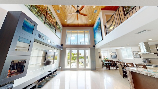 living room featuring light tile patterned floors, a towering ceiling, wooden ceiling, and french doors