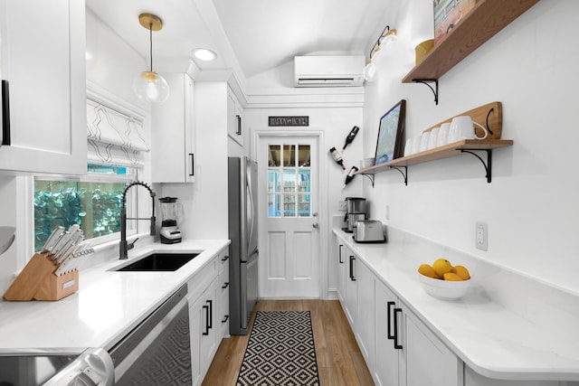 321 Julia St, Key West, FL 33040 - kitchen featuring a wall mounted air conditioner, stainless steel appliances, light wood-style floors, white cabinets, and open shelves