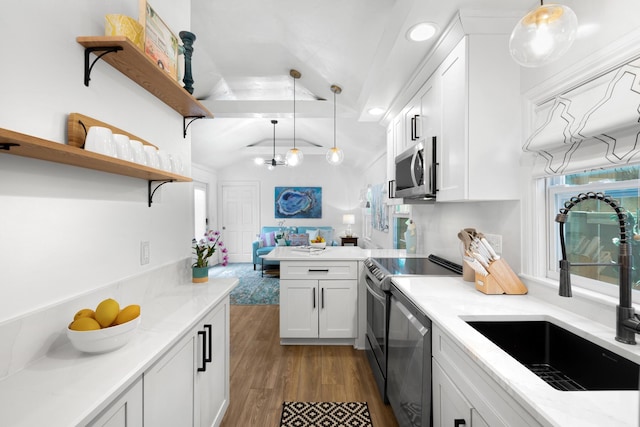 321 Julia St, Key West, FL 33040 - kitchen featuring appliances with stainless steel finishes, vaulted ceiling, dark wood-style floors, hanging light fixtures, and white cabinets