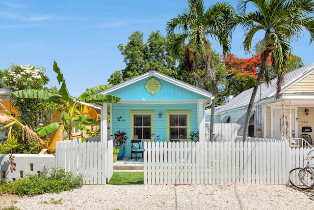 321 Julia St, Key West, FL 33040 - shotgun-style home with a porch and a fenced front yard