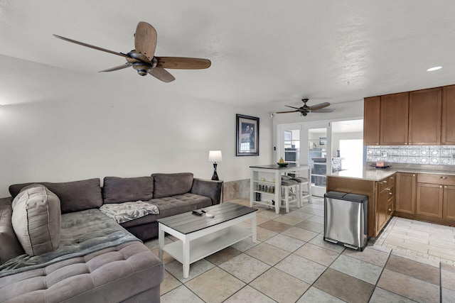 tiled living room with ceiling fan