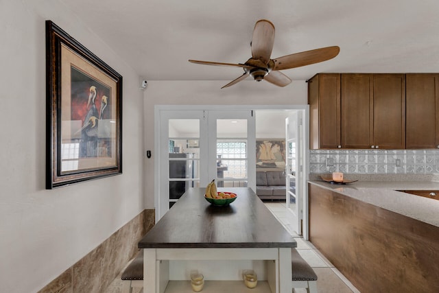 dining room featuring light tile patterned flooring and ceiling fan