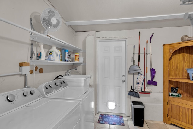 washroom with sink, light tile patterned floors, and washer and dryer